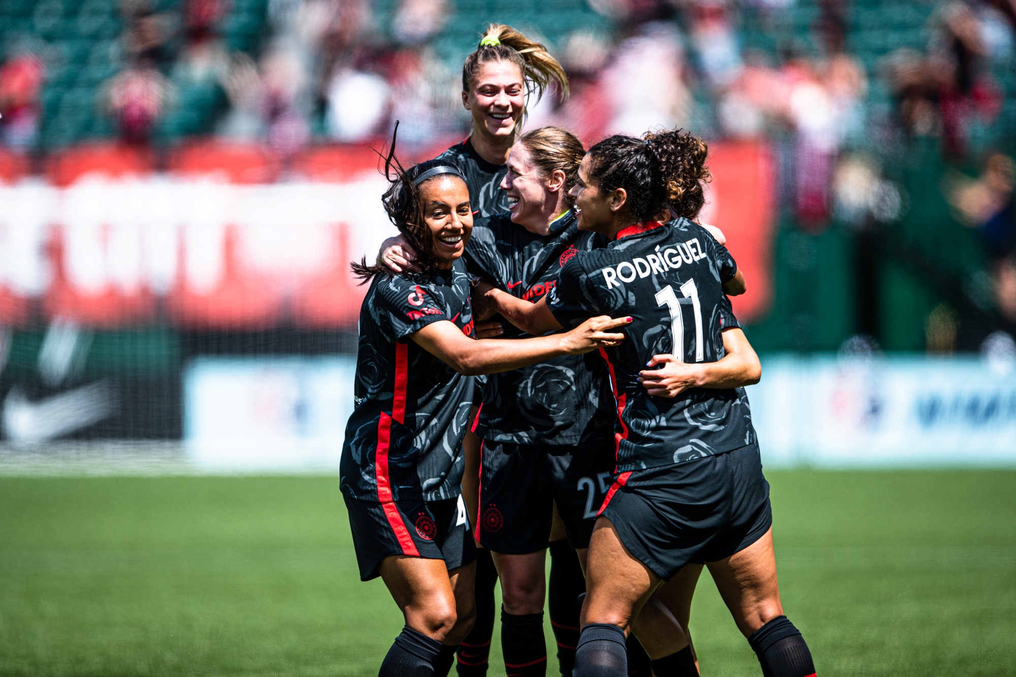 Marissa Everett, Kelli Hubly, Meghan Klingenberg, and Rocky Rodríguez celebrating